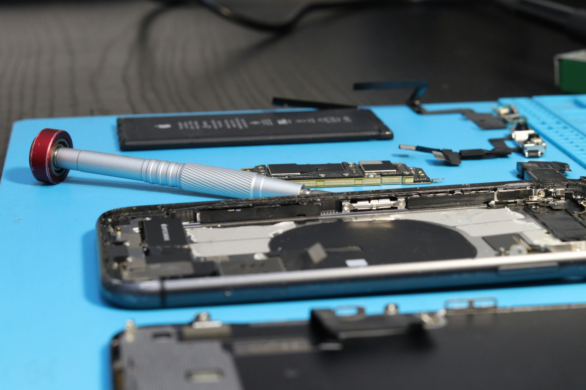 An iPhone is being repaired with components